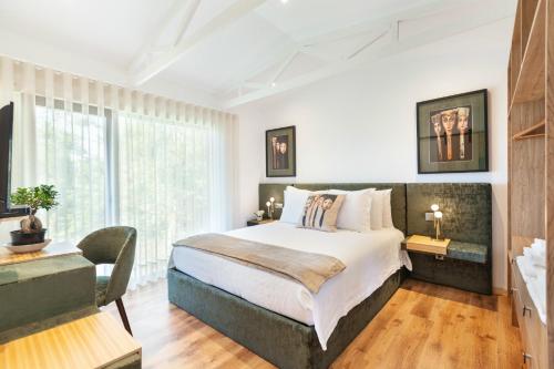a bedroom with a large bed and a large window at Casa do Monte da Veiga - Minho's Guest in Póvoa de Lanhoso