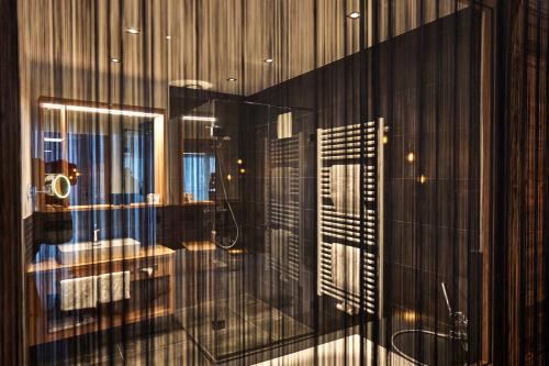 a reflection of a bathroom in a glass window at Wellness- und Bierhotel Adam Bräu in Bodenmais