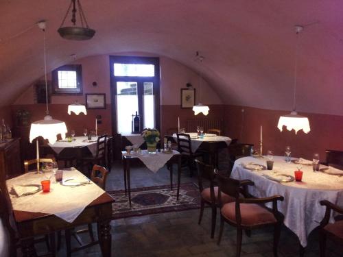 a dining room with tables and chairs and lights at Casa del Contrabbandiere in Pozzolengo