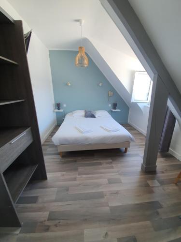 a bedroom with a bed and a blue ceiling at La Marine in Carnac