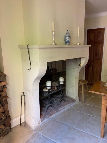 a fireplace with two candles on top of it at L'aile du Chateau in Ramatuelle