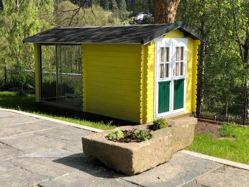 a small yellow and green house with a window at Ferienhaus Sandy in Bad Elster