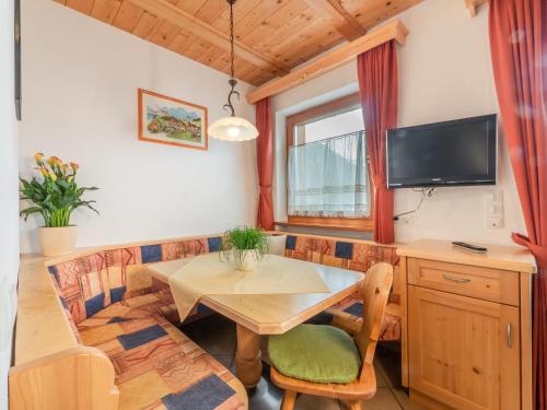 a living room with a table and a couch at Ciasa Raut in La Valle