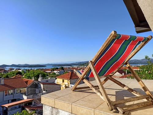 a chair sitting on top of a roof at Apartment Baratula in Murter