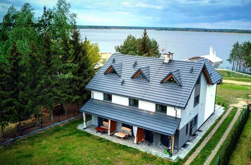 an aerial view of a white house with a roof at Żubr Nad Zalewem in Łuka