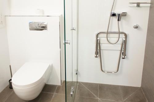 
a bathroom with a toilet and a shower stall at Hotel Boutique Villa Lorena by Charming Stay in Málaga
