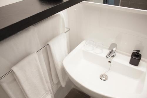 a white bathroom with a sink and a toilet at BYPILLOW Villa Lorena Adults Recommended in Málaga