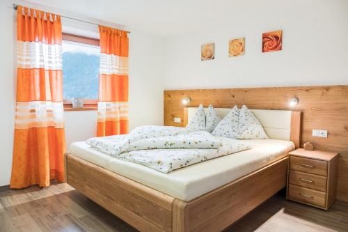 a bedroom with a large bed and a window at Hofschenke Pfeiftal - Almenrausch in San Martino