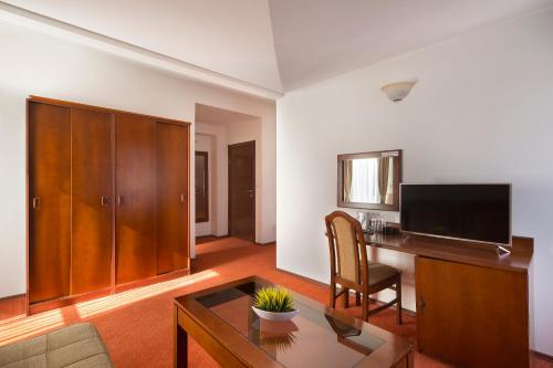 a living room with a desk and a television at Villa Ljubanovic in Budva