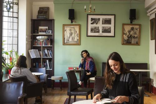 a woman sitting at a desk in a library at Strand Continental in London