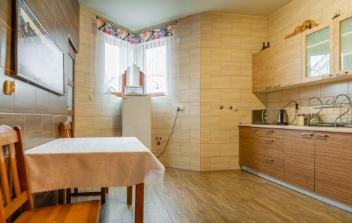 a kitchen with a table and a counter top at U Repy in Bańska
