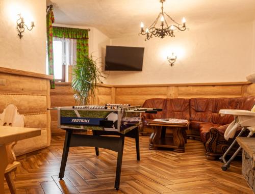 a living room with a table and a couch at U Repy in Bańska