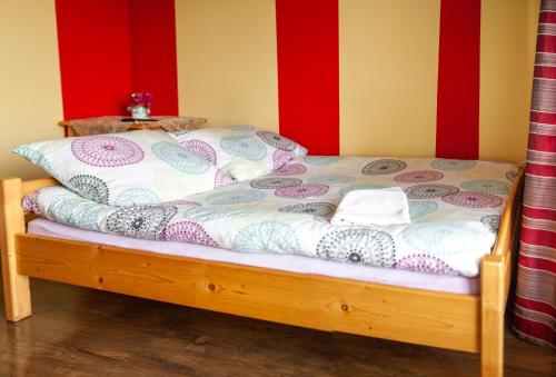 a bed in a room with red and yellow walls at U Repy in Bańska