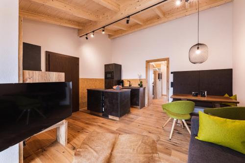 a living room with a large flat screen tv at Michelerhof - kinderfreie Unterkunft in Lavant