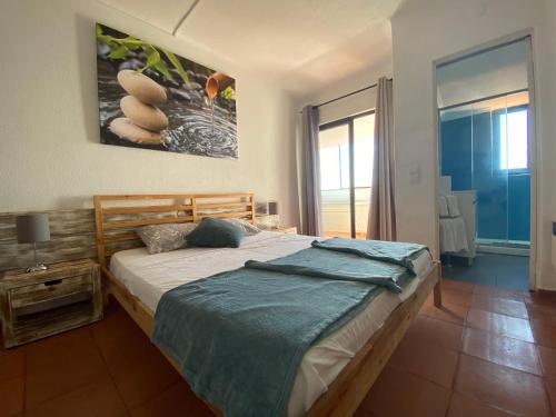 a bedroom with a bed and a large window at Algarve Vacations Flat in Albufeira