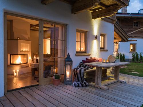 a patio with a table and a fireplace at Hüttendorf Ladizium in Ladis