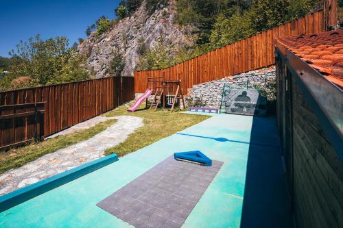 a backyard with a play yard with a playground at Pension Fialka in Český Krumlov