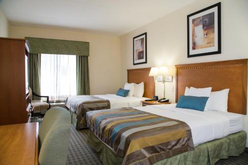 a hotel room with two beds and a window at Wingate by Wyndham Atlanta Fairburn in Fairburn