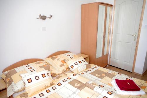 a bedroom with a bed with boxes on it at Fehér Hajó Panzió és Vendéglő in Győr
