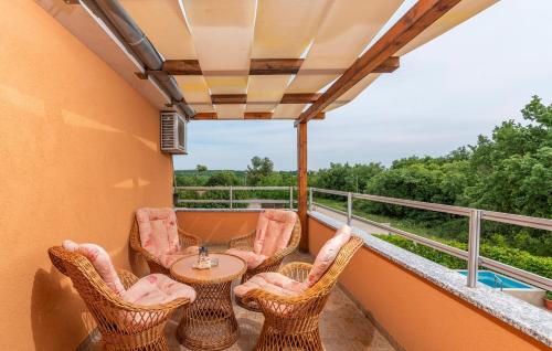 a balcony with a table and chairs on a balcony at Apartment Complex Villa Visnjan with Pool in Višnjan