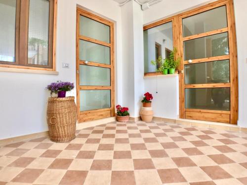 an empty room with doors and potted plants at Terrazza sul mare Pisciotta - Palinuro in Pisciotta