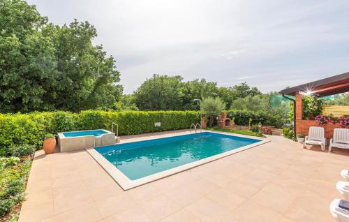 a swimming pool in a yard with a patio at Apartment Complex Villa Visnjan with Pool in Višnjan