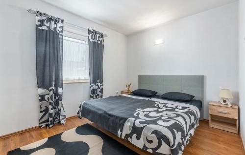 a bedroom with a bed with a black and white blanket at Apartment Complex Villa Visnjan with Pool in Višnjan