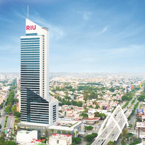 a tall building with a rru sign on top of it at Riu Plaza Guadalajara in Guadalajara