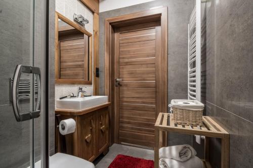 a bathroom with a toilet and a sink at Villa Adamo & Relax in Zakopane