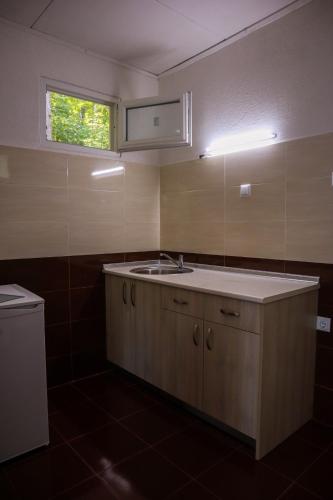 a kitchen with a sink and a window at Бунгала Камена - Bungalows Kamena in Kamena