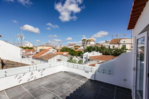a balcony with a view of a city at Casa dos Castelos in Évora