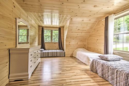 a bedroom with two beds in a log cabin at Lake View and Hot Tub Wrightsville Cabin! in Wrightsville