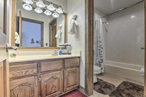 a bathroom with a sink and a mirror and a tub at 2 Mi to Lake Dillon Spacious Condo with Mtn Views in Dillon