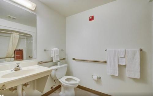 a bathroom with a sink and a toilet and a mirror at Studio 6-Indianapolis, IN in Indianapolis