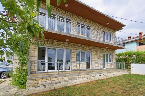 a house with large windows on the side of it at Apartment Patrik by Rent Istria in Umag