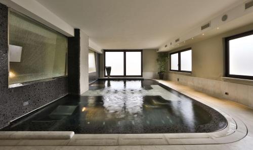 an indoor swimming pool in a building with water at Best Western Hotel Globus City in Forlì