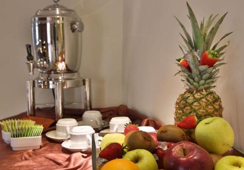 a table with fruit on it with a pineapple at Best Western Hotel Globus City in Forlì