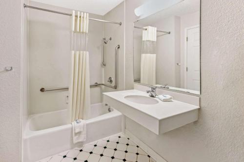 a white bathroom with a sink and a shower at La Quinta Inn by Wyndham Las Cruces Mesilla Valley in Las Cruces