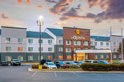 a hotel with cars parked in a parking lot at La Quinta by Wyndham Manassas Battlefield in Manassas