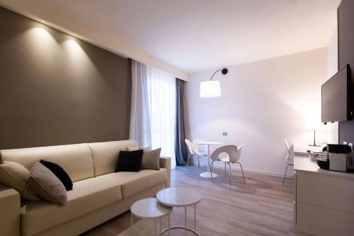 a living room with a couch and a table at Best Western Plus Tower Hotel Bologna in Bologna