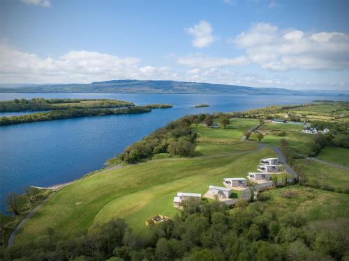 an aerial view of a house next to a lake at Executive Lakeside Lodge at Mullans Bay in Kesh