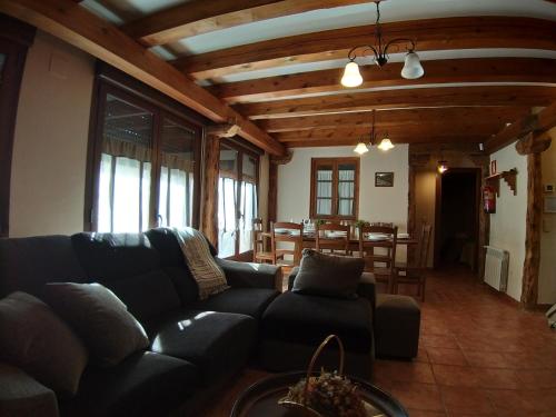 a living room with a couch and a table at Casa Rural LA FUENTONA in Valle de Tabladillo