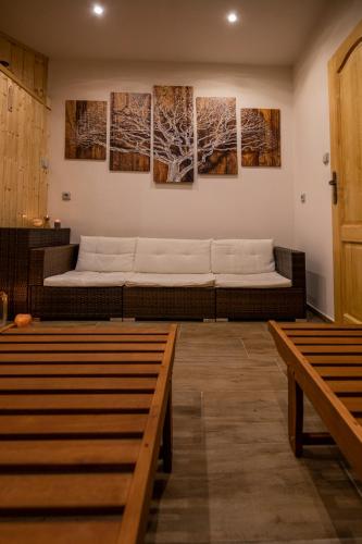 a room with a couch and paintings on the wall at Penzion u Vichu in Červená Voda