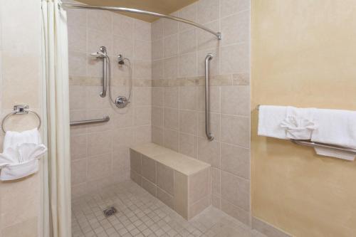 a bathroom with a shower with a glass door at Adara Palm Springs in Palm Springs