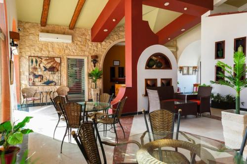 a patio with chairs and a table in a building at Golden Ocean Marina Hotel in El Alamein