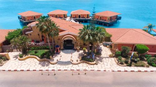 an aerial view of a house with the ocean behind it at Golden Ocean Marina Hotel in El Alamein