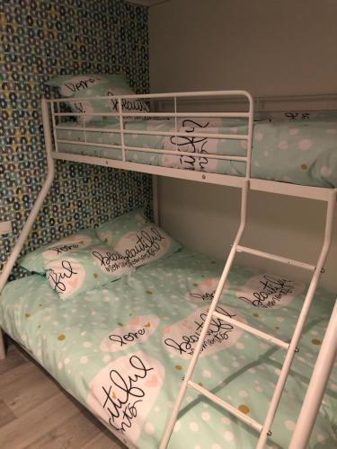 a bunk bed with writing on the bottom bunk at Auberge des platanes in Villevocance