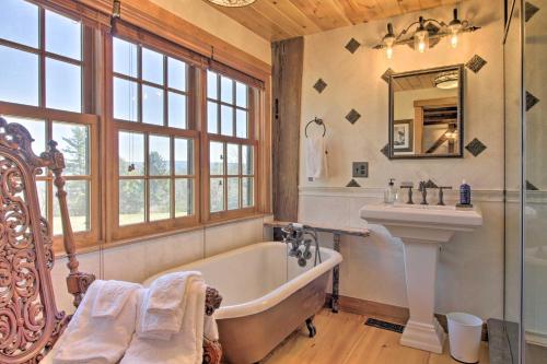 a bathroom with a tub and a sink at Timeless Red Sox Retreat with Scenic Mountain Views! in Putney