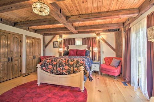 a bedroom with a bed and a red chair at Timeless Red Sox Retreat with Scenic Mountain Views! in Putney