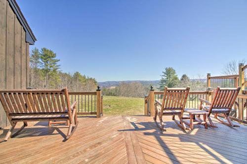 three wooden benches sitting on a wooden deck at Timeless Red Sox Retreat with Scenic Mountain Views! in Putney